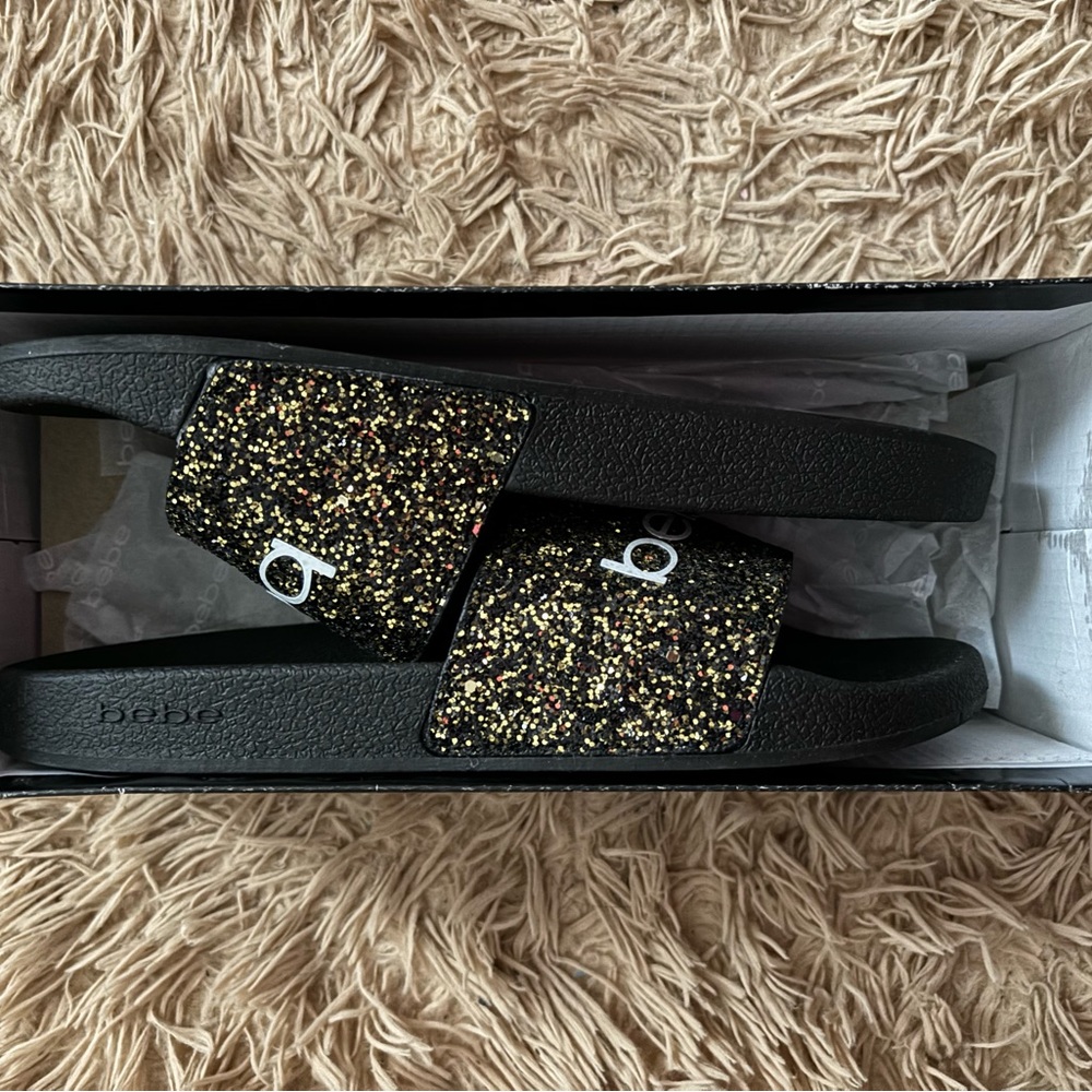 Sparkly gold and black womens BeBe sandals